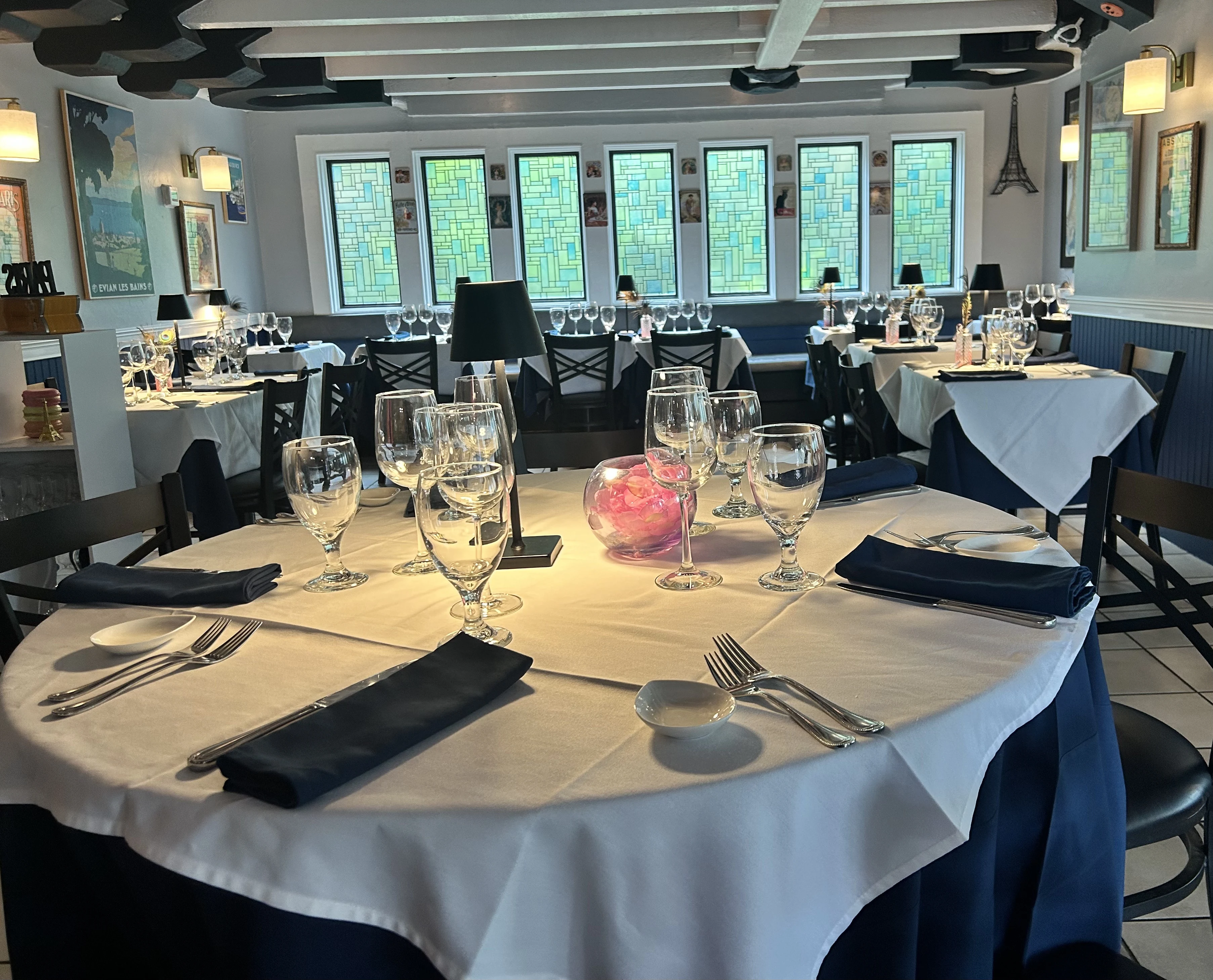 The intimate dining room at Bleu RendezVous, prepared for dinner